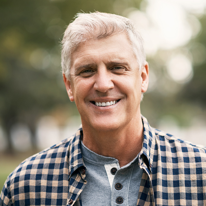 Portrait of a happy senior man spending the day in the park