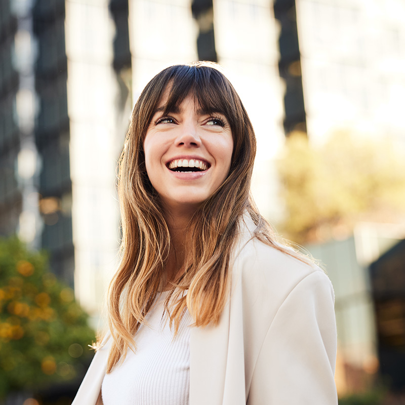 Young Professional Walks, Looking Back with a Broad Smile